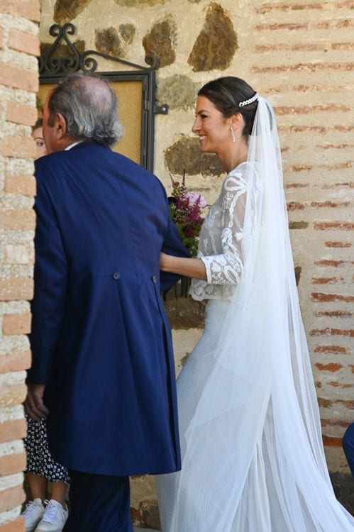 La novia entra a la iglesia del brazo del padrino