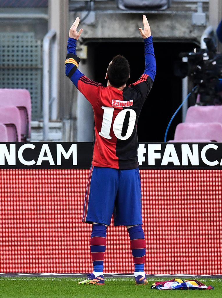 BARCELONA, SPAIN - NOVEMBER 29: Lionel Messi of Barcelona celebrates after scoring their sides fourth goal while wearing a Newell's Old Boys shirt with the number 10 on the back in memory of former footballer, Diego Maradona, who recently passed away during the La Liga Santander match between FC Barcelona and C.A. Osasuna at Camp Nou on November 29, 2020 in Barcelona, Spain. Sporting stadiums around Spain remain under strict restrictions due to the Coronavirus Pandemic as Government social distancing laws prohibit fans inside venues resulting in games being played behind closed doors. (Photo by David Ramos/Getty Images)