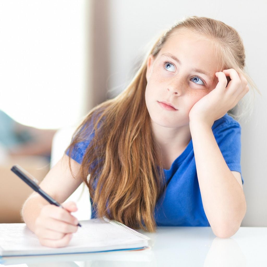 Young girl at home thinking about her schoolwork