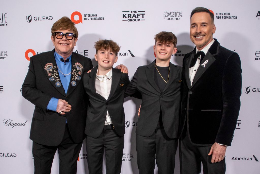 British singer-songwriter Elton John and his partner David Furnins pose with their sons Zachary Jackson Furnish and Elijah Joseph Daniel Furnish as they attend the 33rd Annual Elton John AIDS Foundation Academy awards viewing party at the Pacific Design Center in West Hollywood, California, on March 2, 2025. (Photo by Apu GOMES / AFP) (Photo by APU GOMES/AFP via Getty Images)          