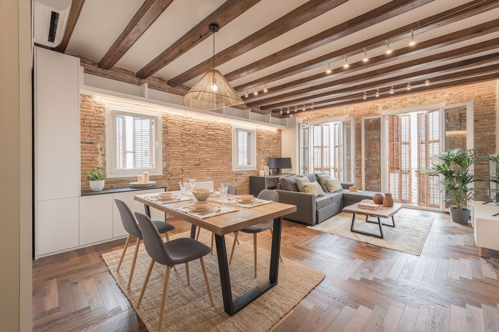 Living room with dining room with brick walls. 