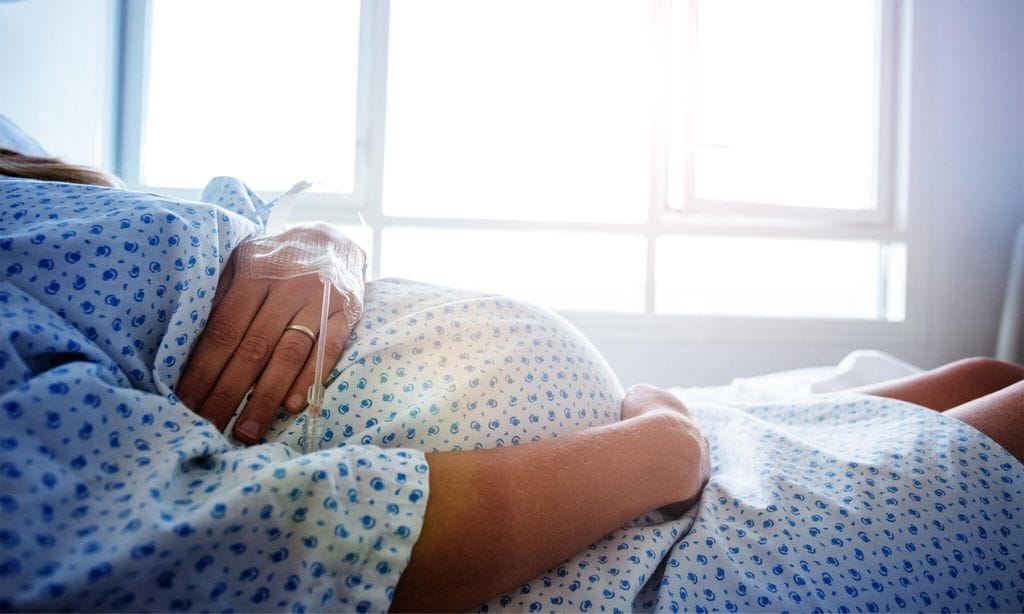 Close-up of a pregnant woman\'s belly in hospital