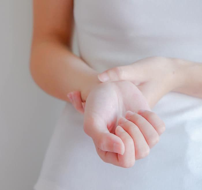 mujer con dolor en la mano