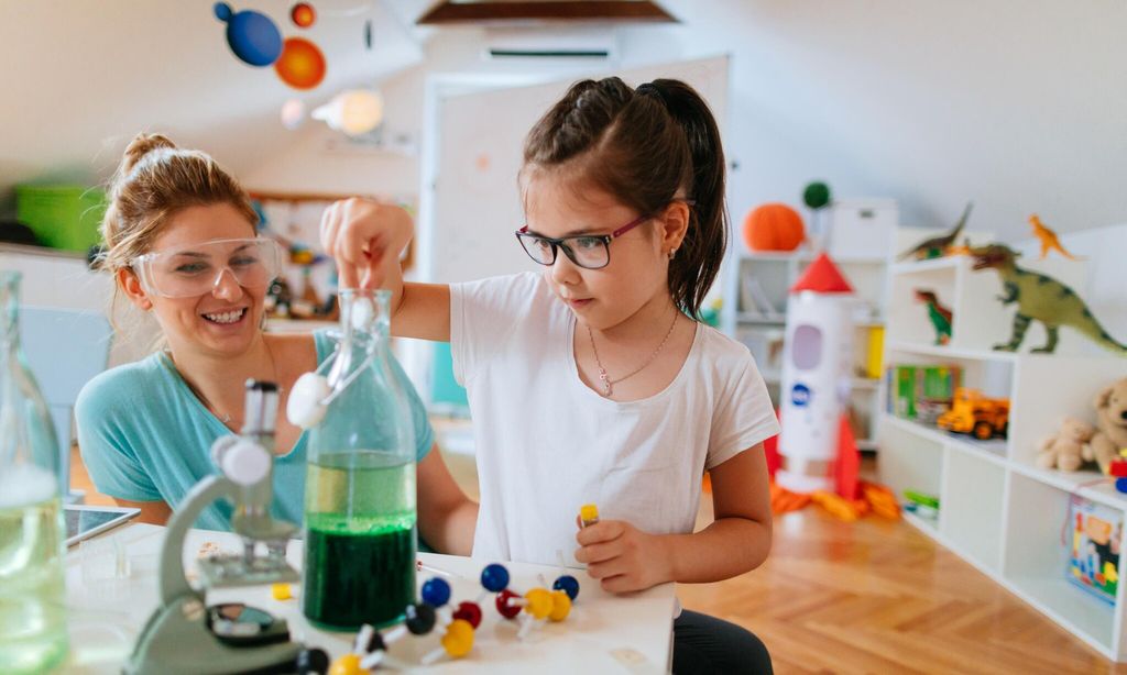 girl and her mother doing scientific experiment