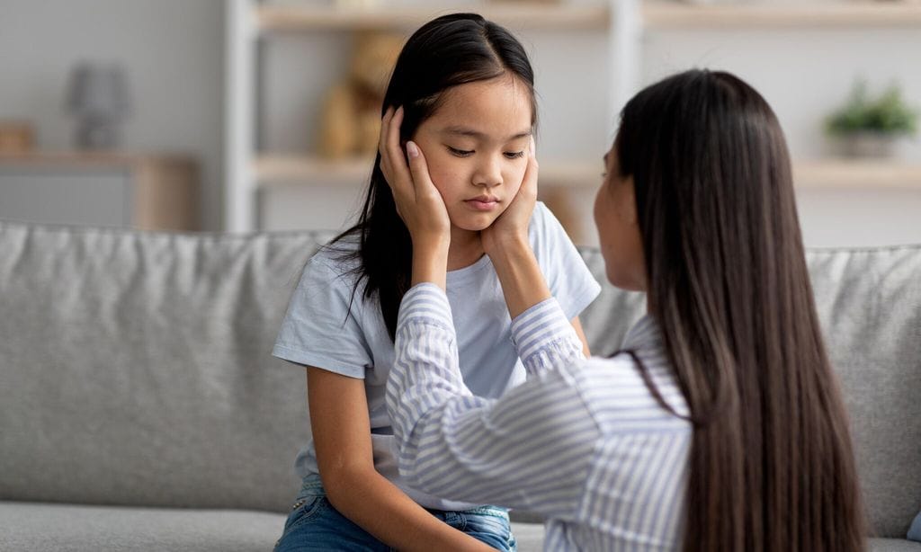 family misunderstanding concept young asian mother calming down her offended daughter after quarrel free space