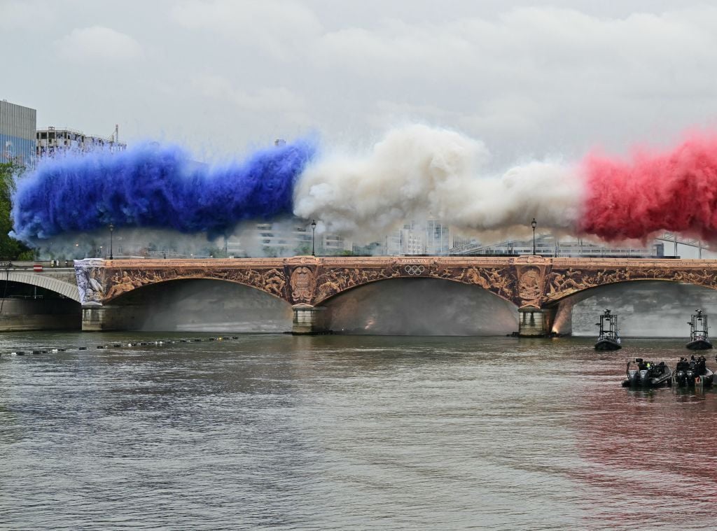 Fireworks in the French national colours explode over Pont d'Austerlitz during the opening ceremony of the Paris 2024 Olympic Games in Paris on July 26, 2024. (Photo by Miguel MEDINA / AFP) (Photo by MIGUEL MEDINA/AFP via Getty Images)