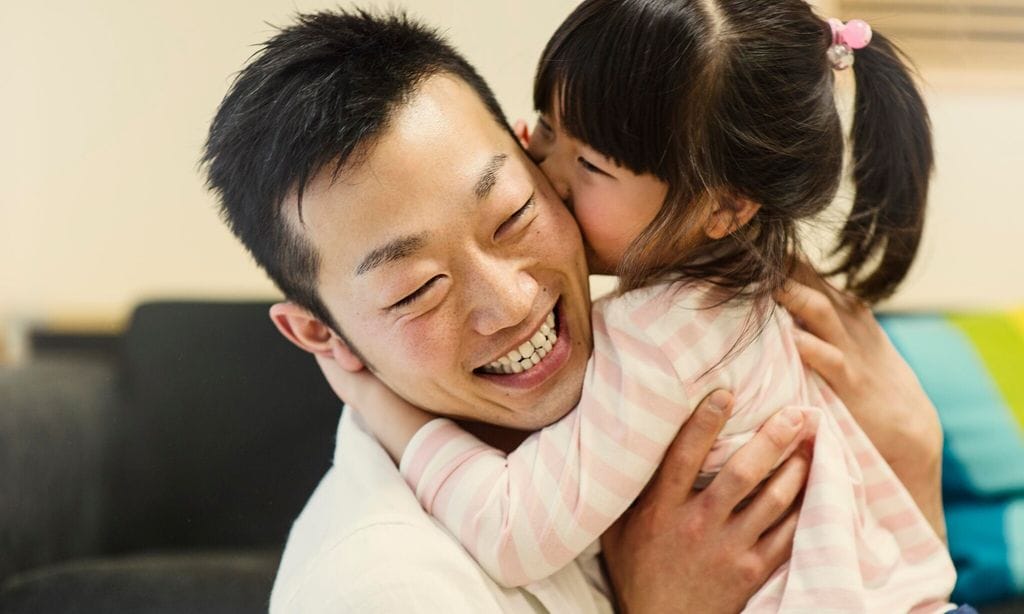 father and daughter playing together at home