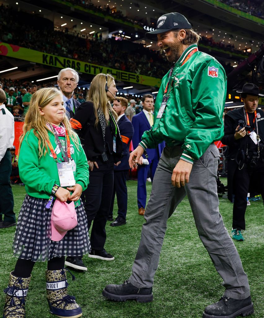 Bradley Cooper and daughter Lea wear matching Philadelphia Eagles jackets on the sideline before the team faces the Kansas City Chiefs during Super Bowl LIX at Caesars Superdome in New Orleans on Sunday, February 9, 2025