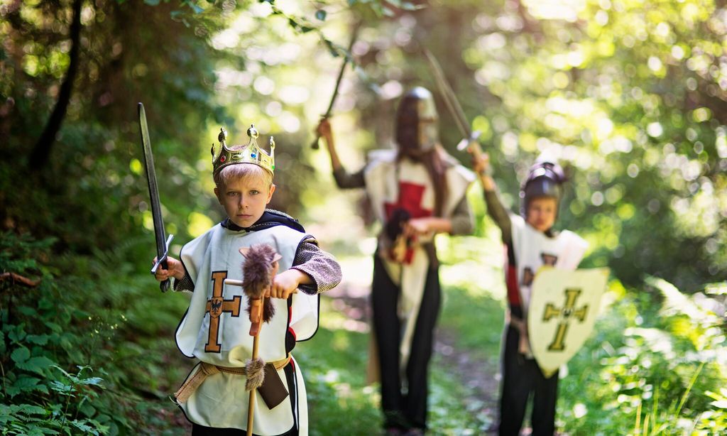 kids playing knights in forest