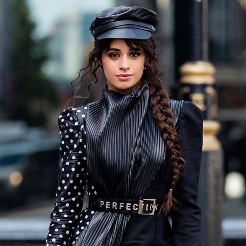 camila cabello with a long braid and leather cap