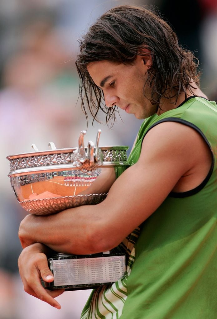 PARIS - JUNE 05:  Rafael Nadal of Spain poses with the winners trophy after his 3-1 set victory over Mariano Puerta of Argentina in the Mens Final match during the fourteenth day of the French Open at Roland Garros on June 5, 2005 in Paris, France.  (Photo by Michael Steele/Getty Images)