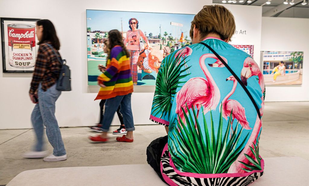 Miami, Florida, Art Basel, Art Miami Context show, person seated wearing pink flamingoes shirt