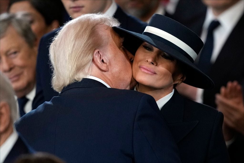 WASHINGTON, DC - JANUARY 20:  U.S. President Donald Trump and Melania Trump kiss during his swearing in in the U.S. Capitol Rotunda on January 20, 2025 in Washington, DC. Donald Trump takes office for his second term as the 47th president of the United States. (Photo by Julia Demaree Nikhinson - Pool/Getty Images)