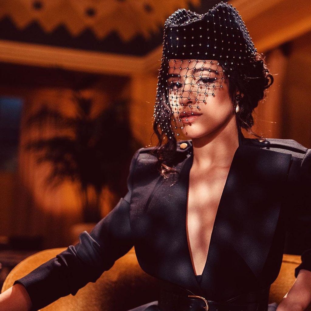 camila cabello with a retro style updo and hat