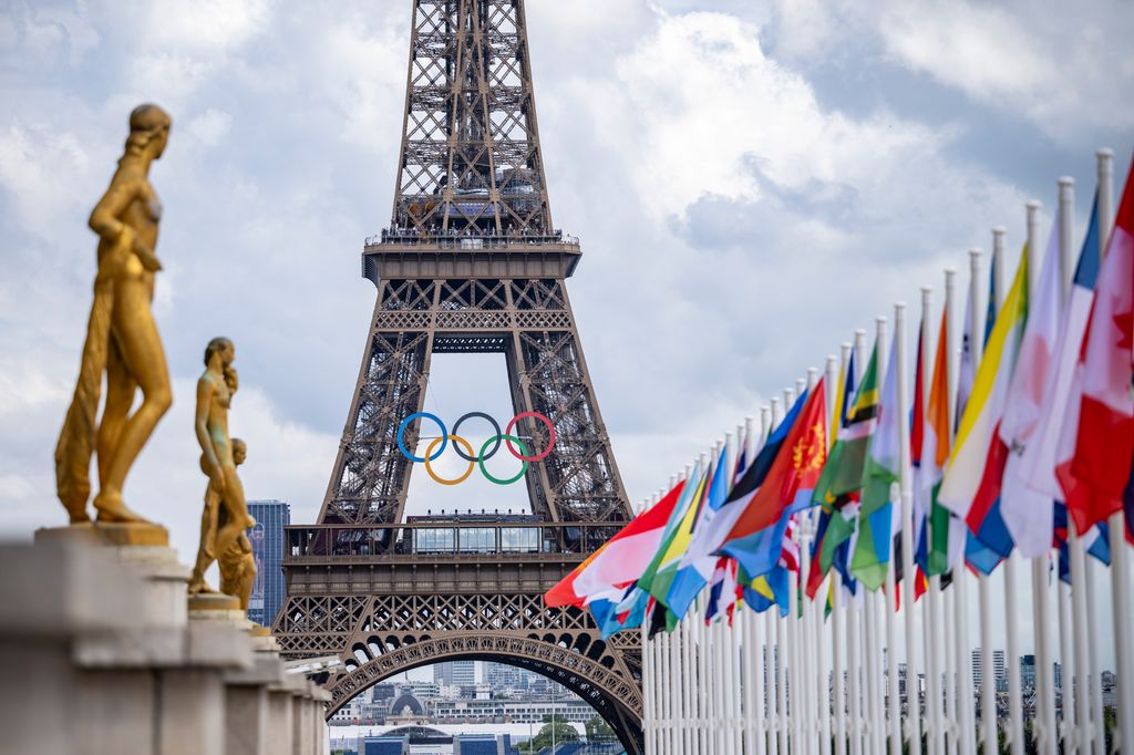 PARIS, FRANCE - JULY 21: A general view of the Eiffel Tower with the Olympics rings pictured with national flags of competing countries from the Place du Trocadero ahead of Paris 2024 Olympic Games  on July 21, 2024 in Paris, France. (Photo by Kevin Voigt/GettyImages)