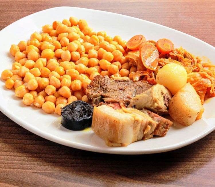 Bandeja de garbanzos, carnes, patata y zanahorias.