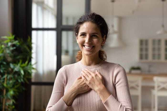 mujer tocándose el corazón