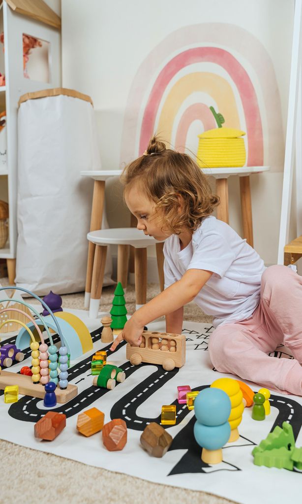 Niña jugando con coches