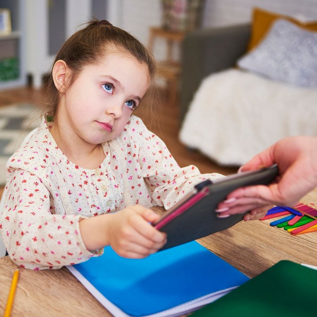 Parent taking away the tablet from child