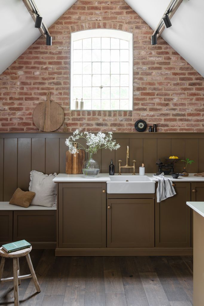 Rustic kitchen with brick wall. 