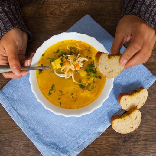 Plato de sopa acompañado de tres rebanadas de pan integral