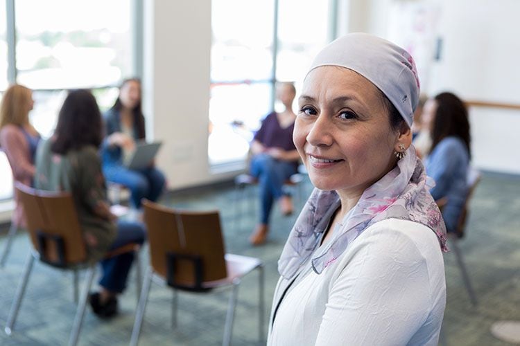 Mujer con cáncer asistiendo a una terapia de grupo