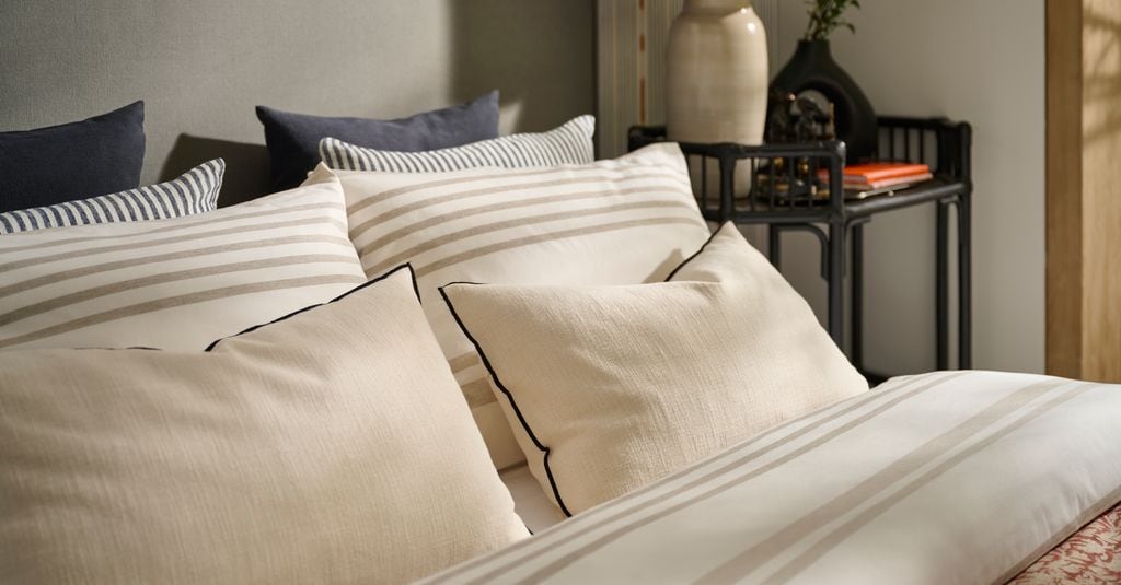 Bed with pillows in neutral tones