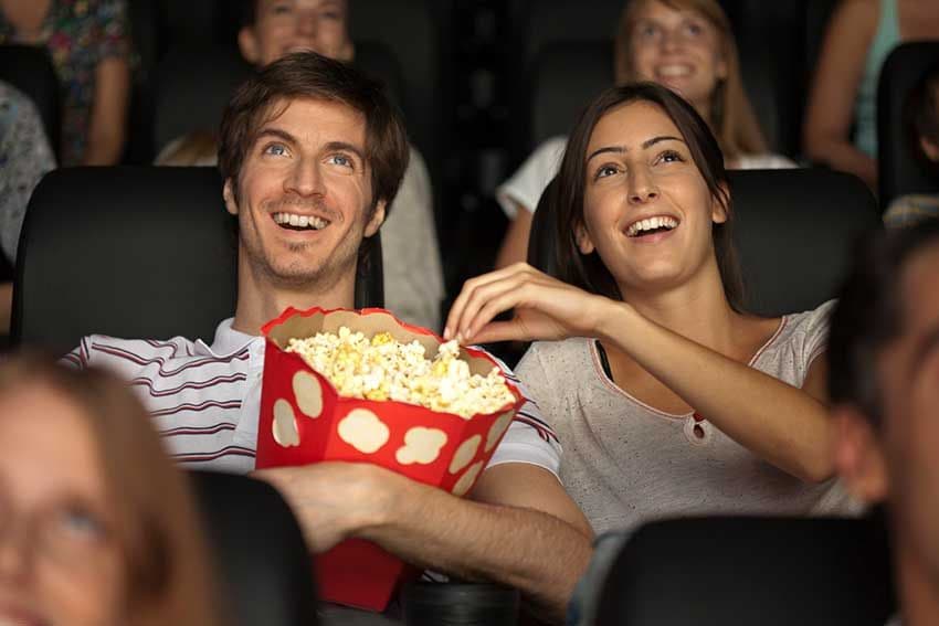 Una pareja comiendo palomitas en el cine