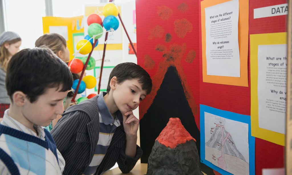 elementary boys with volcano project at science fair