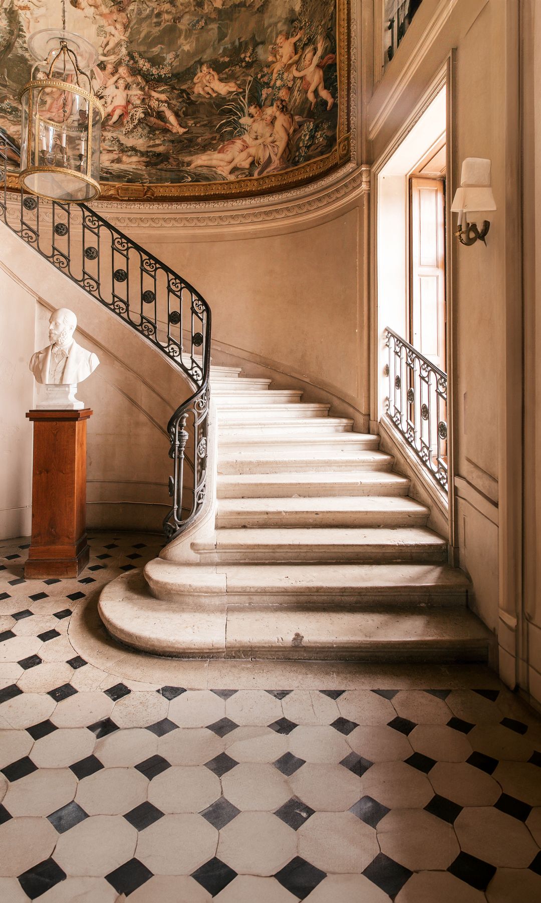 La escalera, decorada con un tapiz de pared de Gobelin, que representa "El sueño de Renaud". 