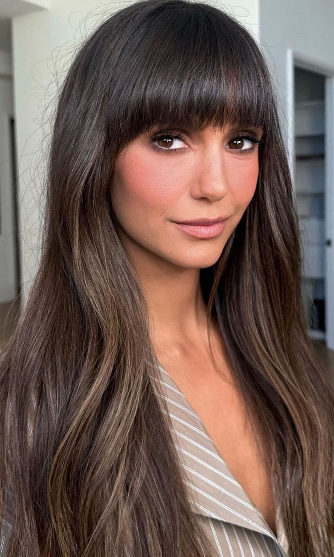 Nina Dobrev with long bangs and makeup by Patrick Ta