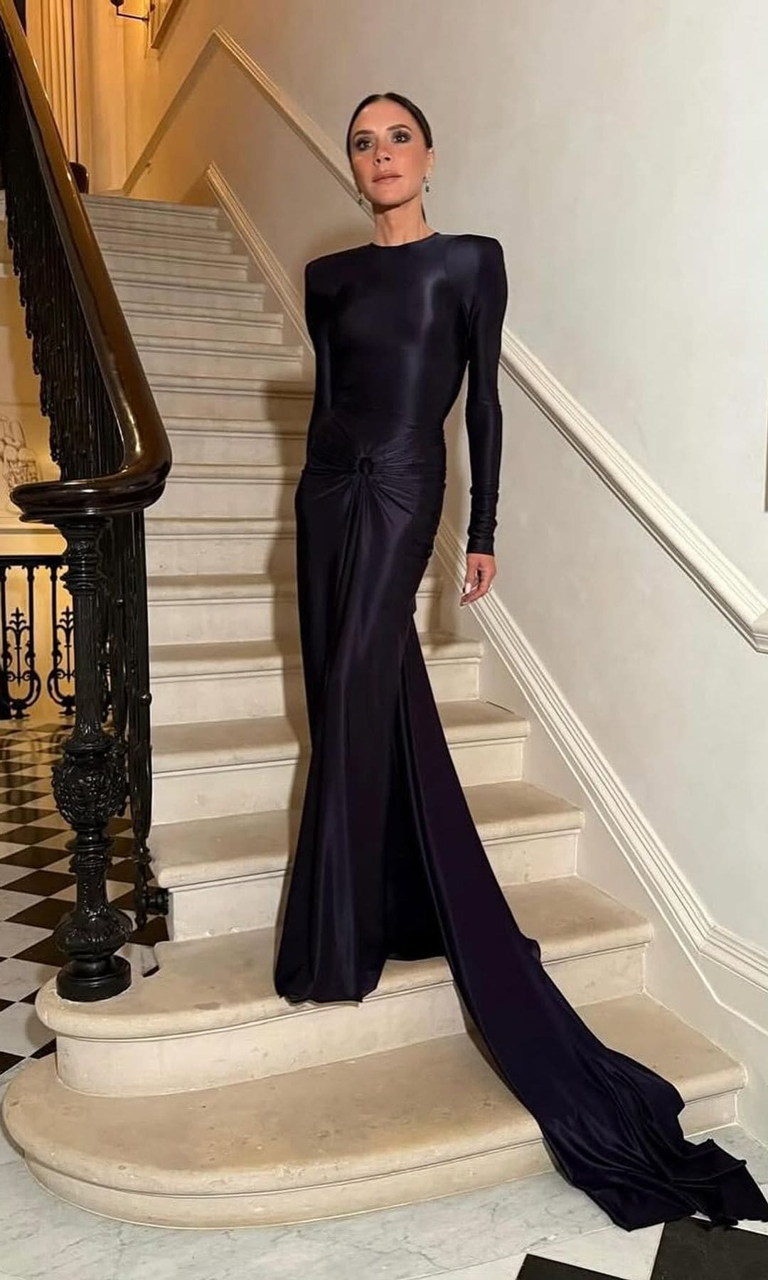 Victoria Beckham con vestido negro de invitada de su propia firma