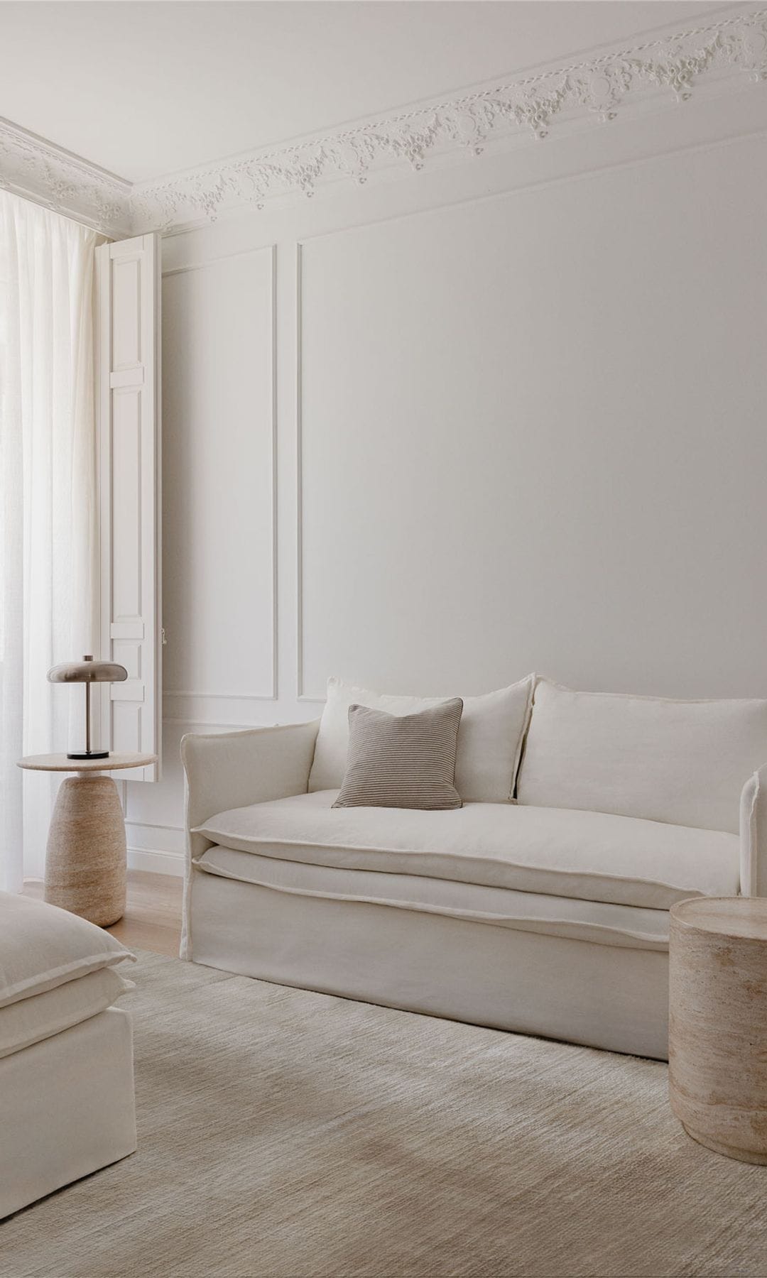 Salón decorado en blanco con molduras en la pared