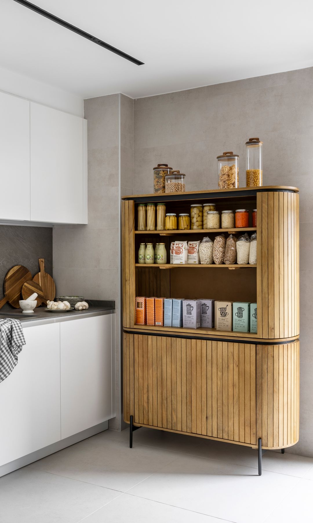 Cocina blanca con mueble despensero de lamas de madera