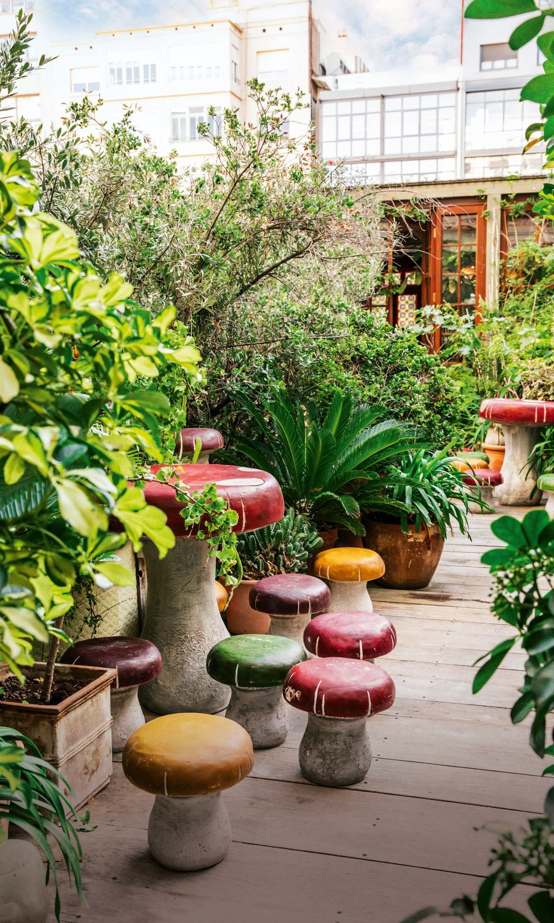 En el salón de la terraza hay esculturas originales no solo de Lázaro, sino también de Botero, muebles de caña de estilo exótico de la Polinesia Francesa, vidrieras 'déco' originales de Barcelona, dos chimeneas paneladas con 'boiseries' francesas, alfombras de Oriente Medio y sofás de creación propia. "Aparte, creamos un pequeño bosque para dar privacidad a la parte social de la casa de una manera muy natural. Quería que diese la sensación de que ese vergel siempre estuvo ahí"