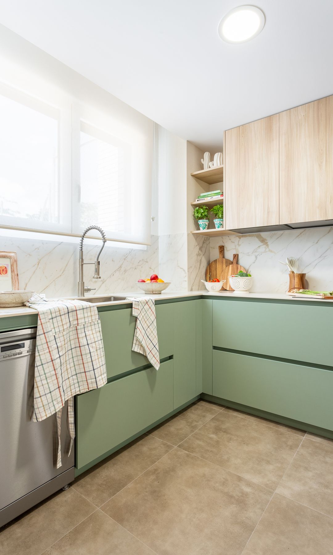 Renovated kitchen with green furniture