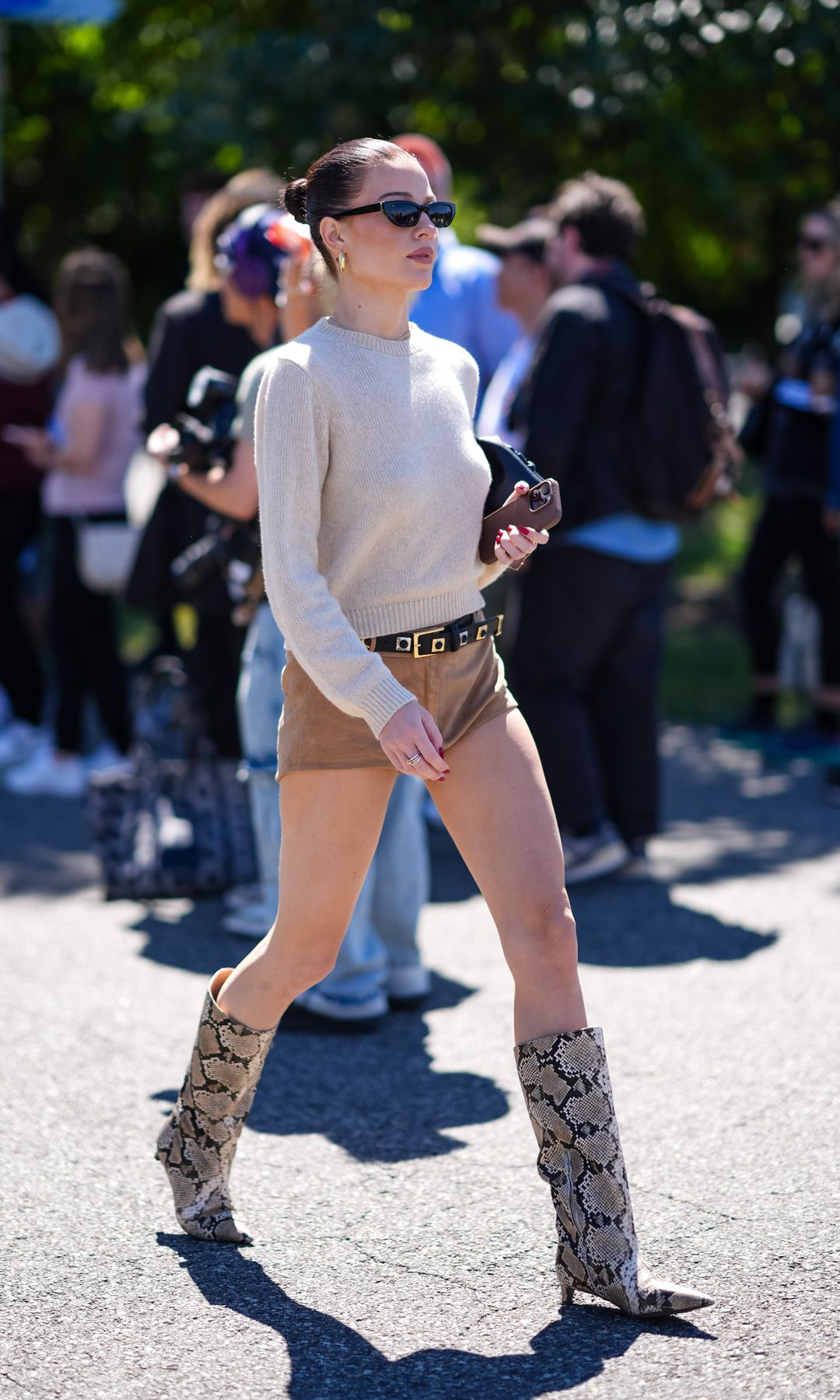 Jersey croppped beige con microshorts y botas altas de serpiente animal print