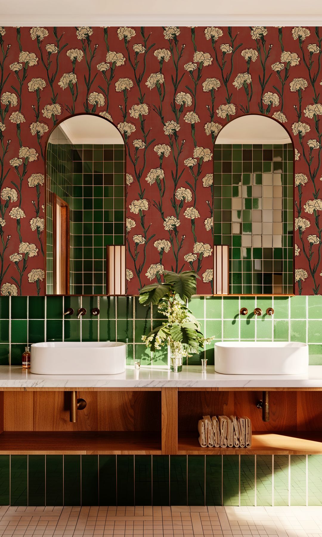 Baño con azulejos verdes y papel pintado de flores burdeos, dos espejos ovalados y mueble bajolavabo suspendido 