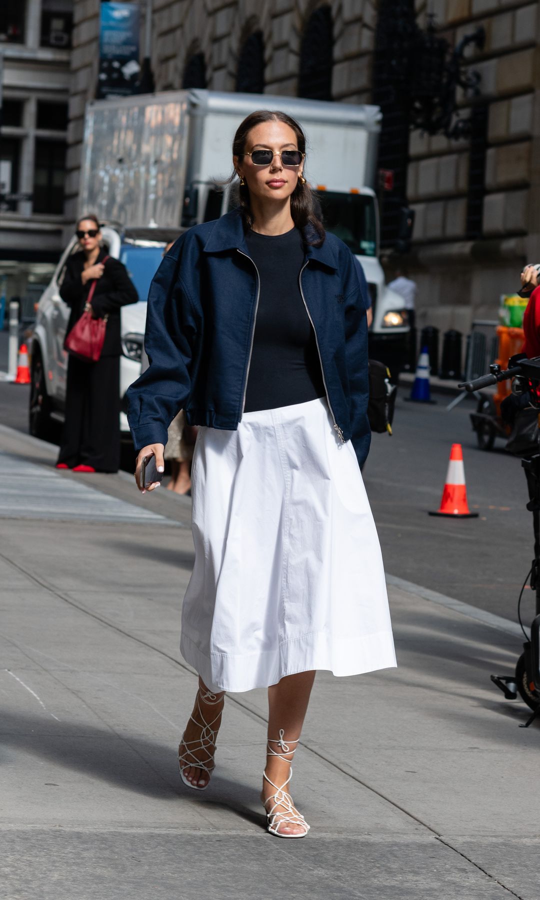 Navy blue bomber jacket and white midi skirt