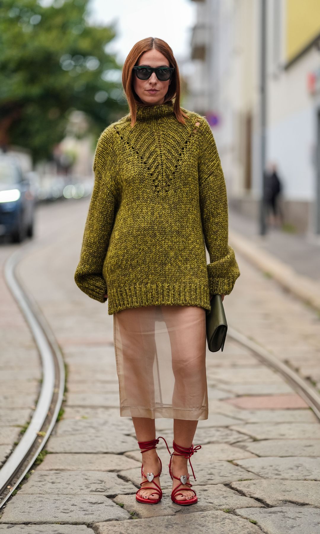 jersey verde oliva, falda semitransparente y tacones rojos 