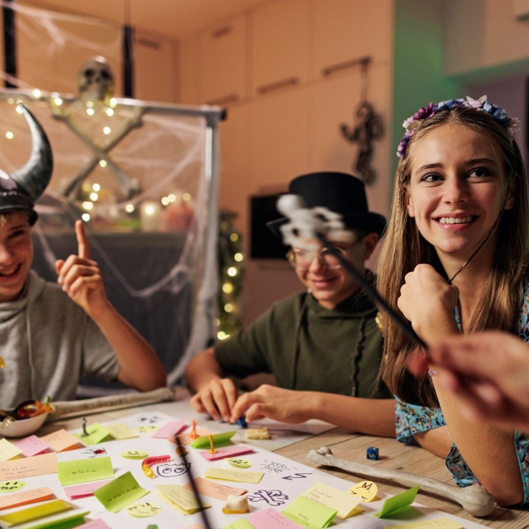 family playing custom board rpg game together at home 