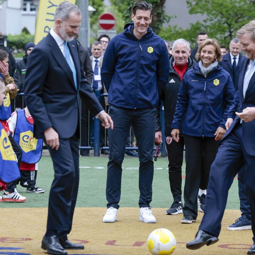 El rey Felipe y Guillermo de Países Bajos saltan al terreno de juego y dan unos toques al balón en la Fundación Cruyff