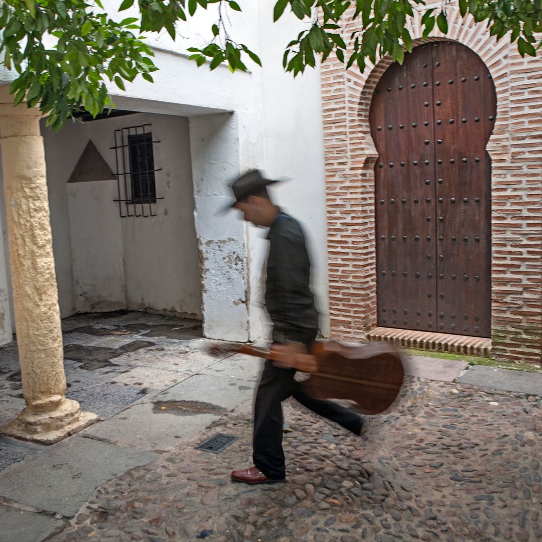 Callejuela de la Judería de Córdoba y músico paseando