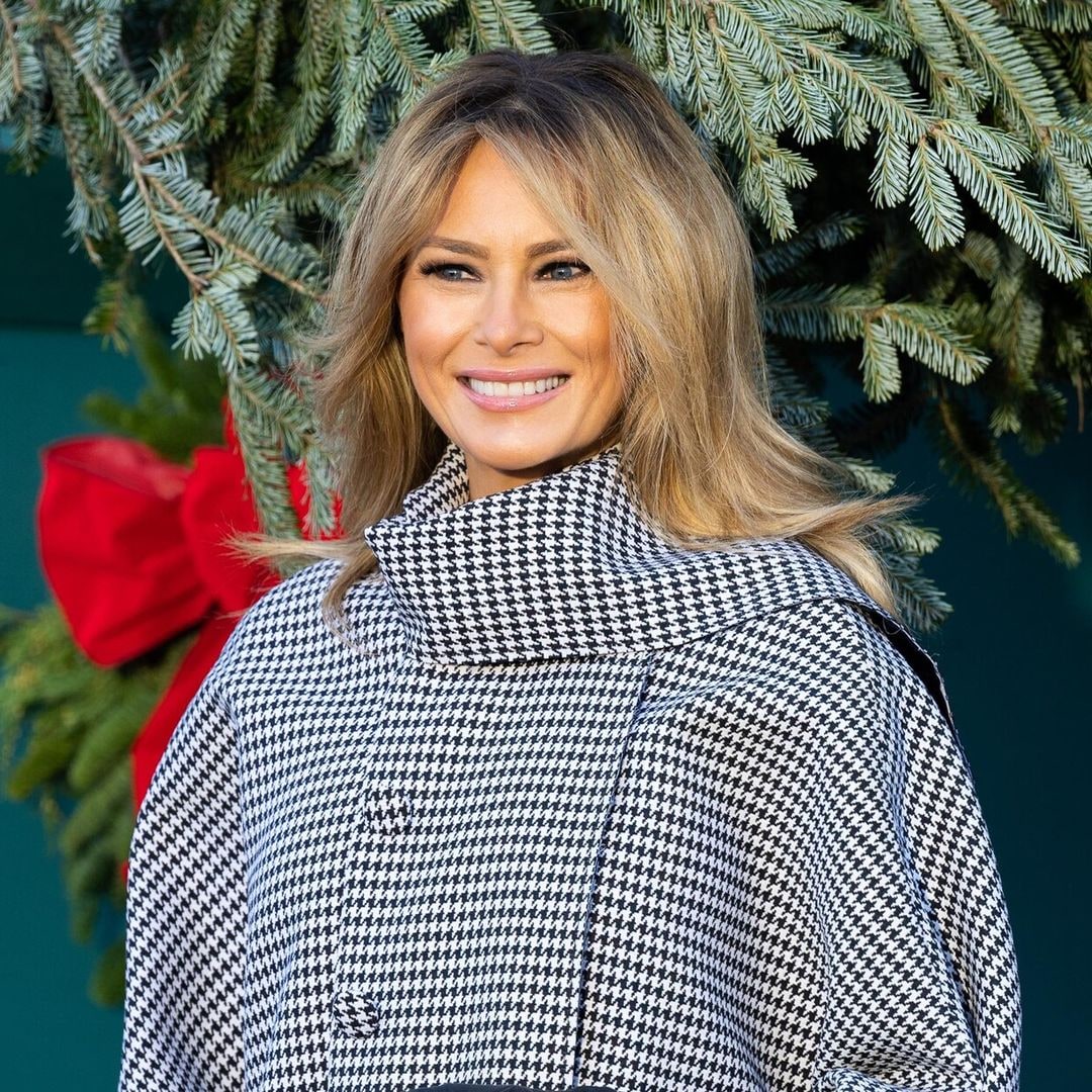 first lady melania trump posing with the carriage that is delivering the white house christmas tree 