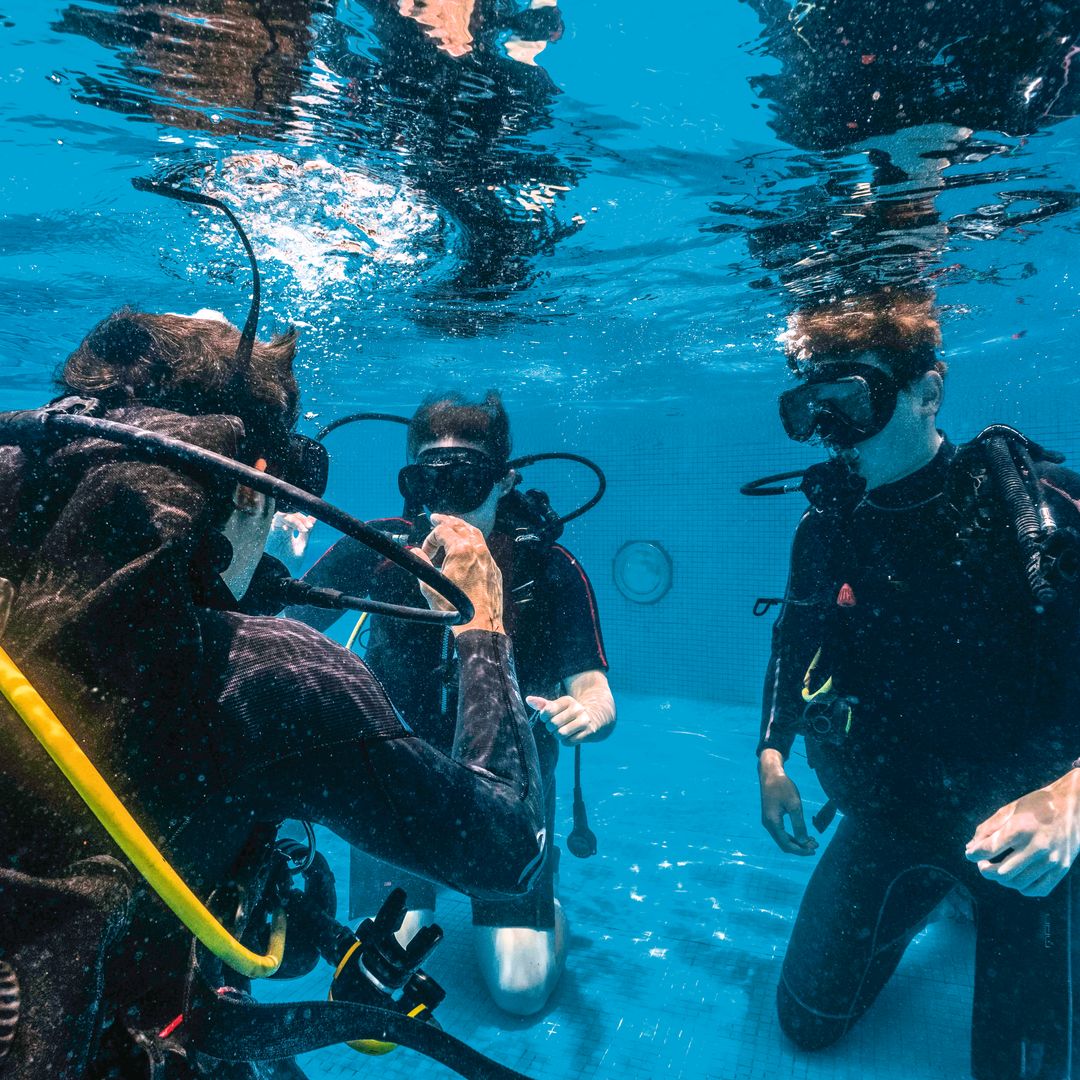 Instructor de submarinismo dando instrucciones a una pareja