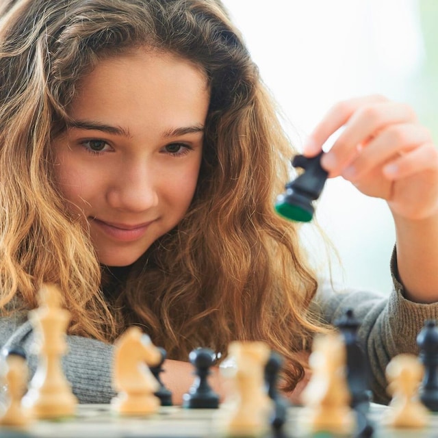 adolescente juega al ajedrez