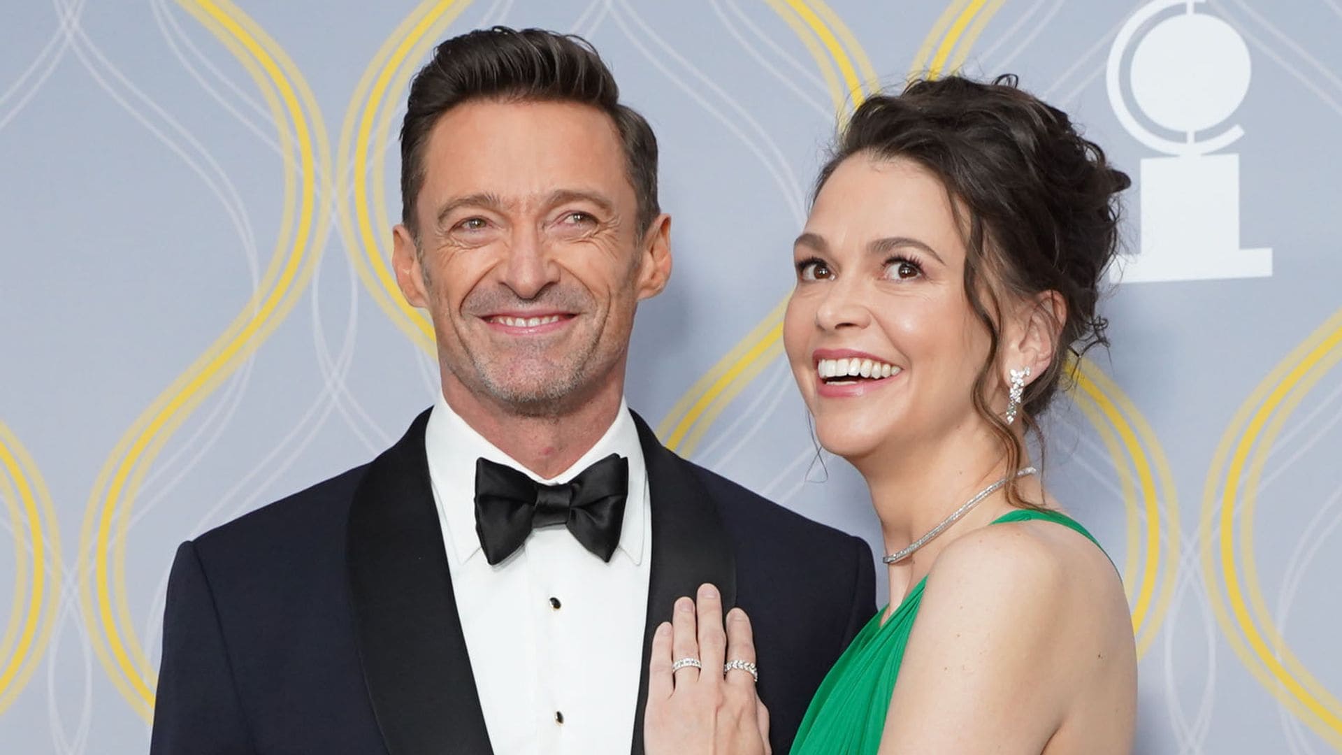 Hugh Jackman and Sutton Foster share a kiss before saying goodbye