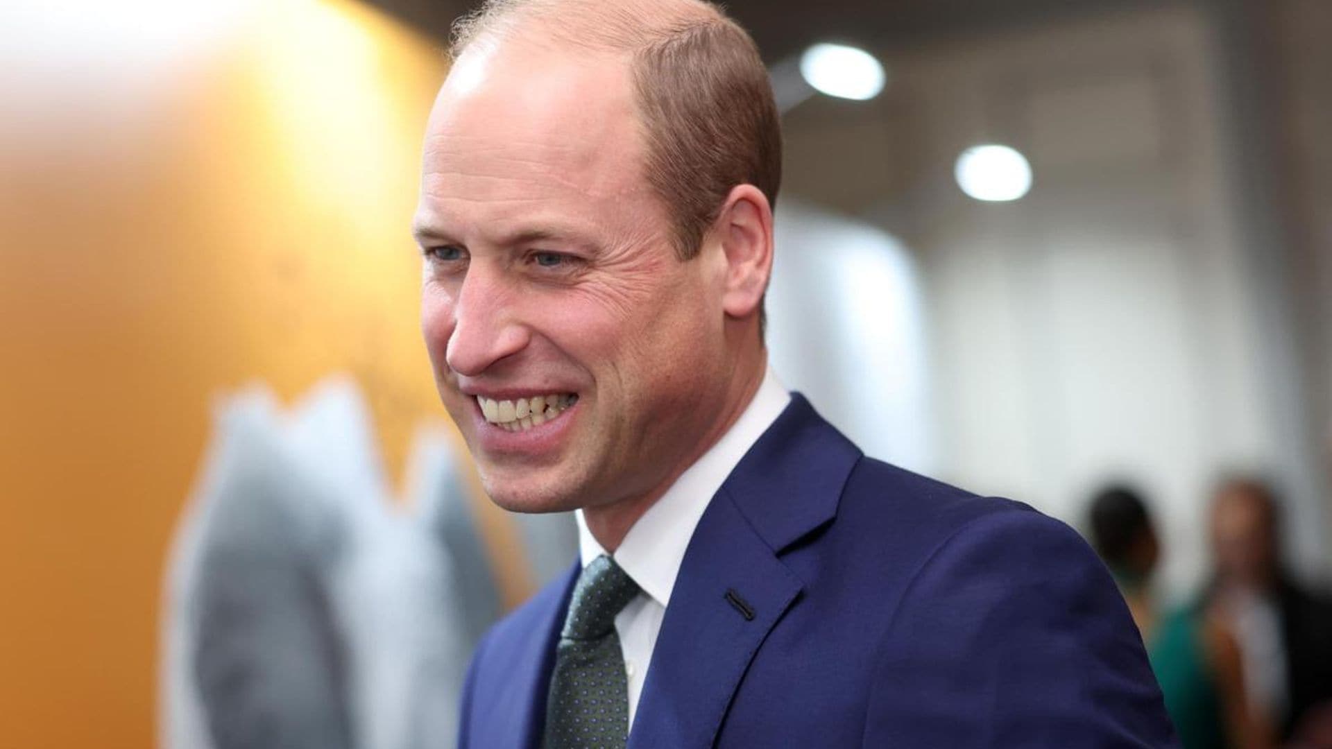 Prince William puts on an apron and prepares food at a Christmas party