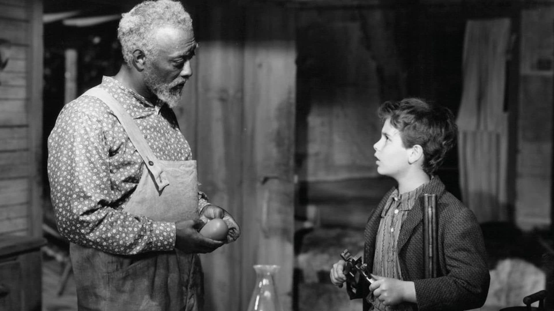 Dean Stockwell learns all about guns from his favorite mentor Juano Hernandez in a scene from the film 'Stars In My Crown', 1950.