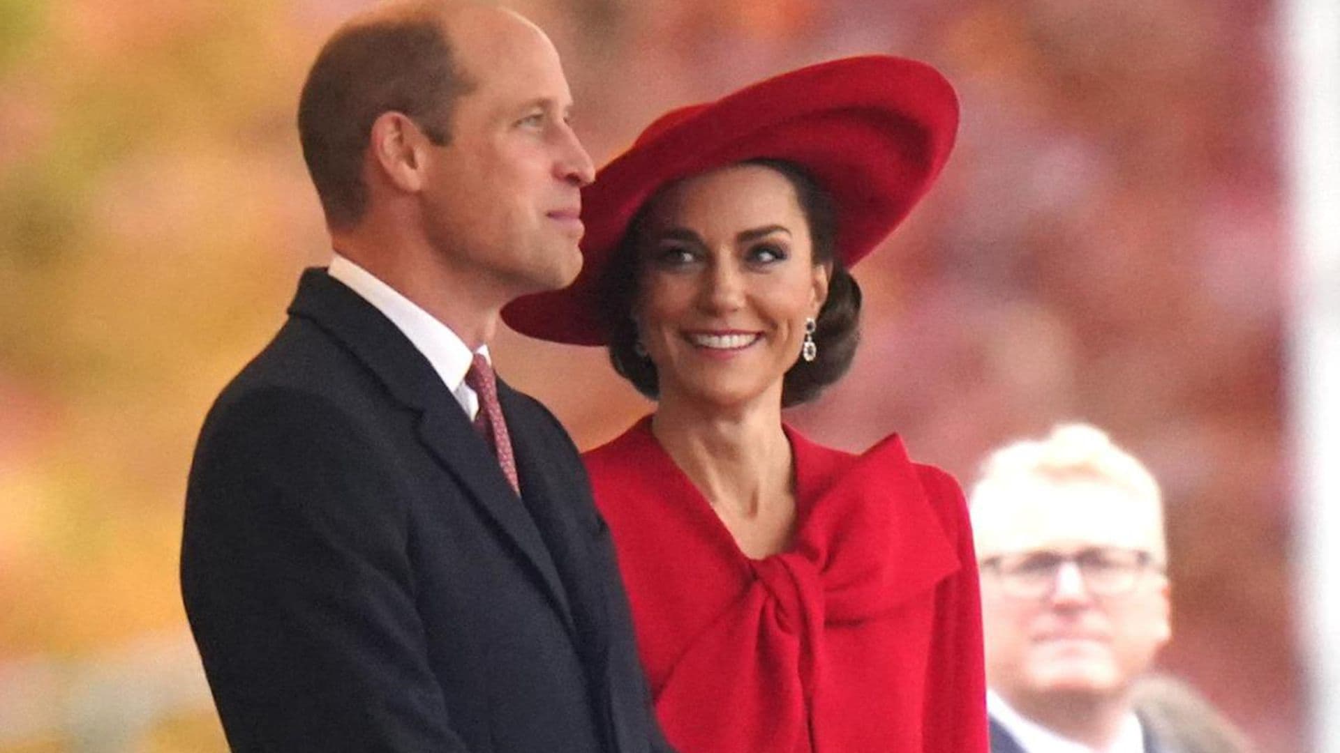 Resplendent in red! The Princess of Wales teams festive bow coat with cape